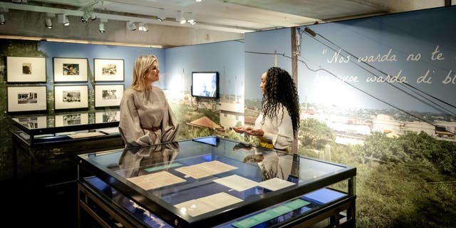 Queen Maxima of the Netherlands, left, visits the Curaçao exhibition in the National Archives in The Hague, on Oct. 6, 2022.