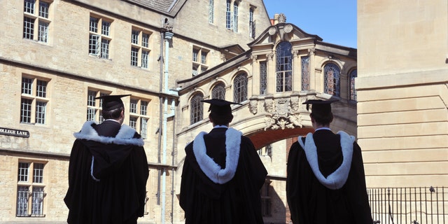 Students at Oxford University near the Hertford Bridge on their way to a graduation ceremony.