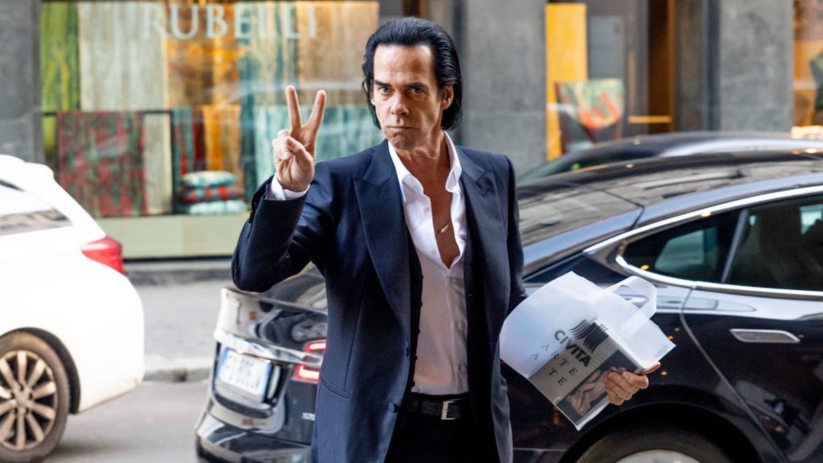 Nick Cave flashes the peace sign in Milan in January 2023