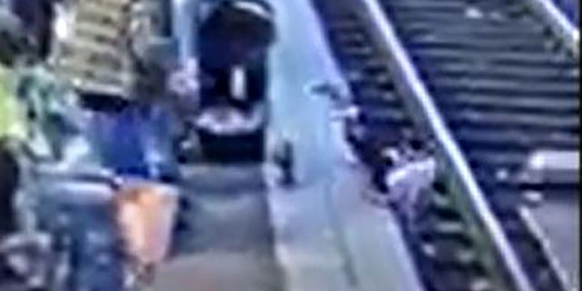 In this still image taken from surveillance video at the Gateway Transit Center MAX platform in Northeast Portland last week, a 3-year-old girl can be seen getting shoved head first onto the railroad tracks.