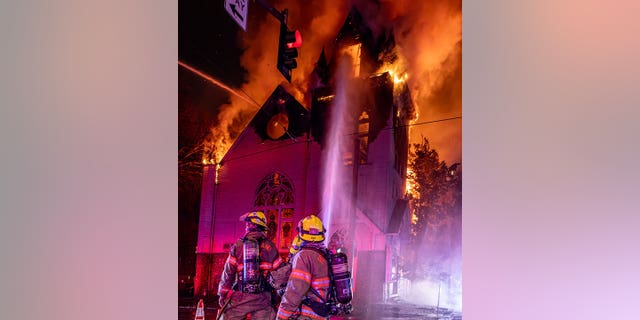 Firefighters use hoses on a massive fire at the Old Portland Korean Church. 