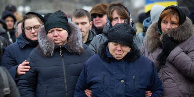 Relatives mourn during a farewell ceremony in Kyiv Jan. 8, 2023, for a Ukrainian soldier Oleh Yurchenko, who was killed in a battle with Russian troops in the Donetsk region.