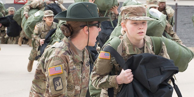 A U.S. Army drill sergeant corrects a recruit during her first day of training at Fort Leonard Wood, Missouri.