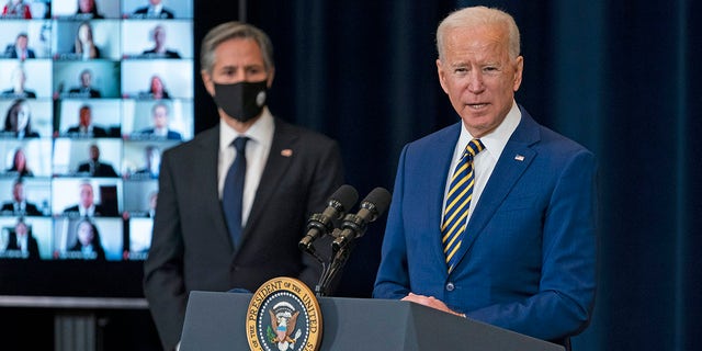 Secretary of State Antony Blinken listens as President Biden delivers remarks to State Department staff on Feb. 4, 2021. 