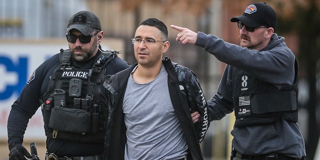 Solomon Pena, a Republican candidate for New Mexico House District 14, is taken into custody by Albuquerque Police officers, on Monday, Jan. 16.