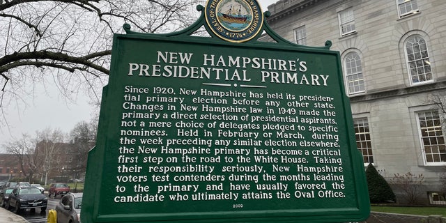 A sign marking New Hampshire's cherished century old tradition of holding the nation's first presidential primary in the White House race stands across the street from the state capitol building, in Concord, N.H., on Dec. 7, 2022.