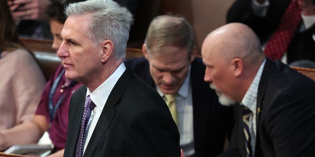 House Republican Leader Kevin McCarthy, R-Calif. arrives in the House Chamber for the second day of elections for Speaker of the House as Rep.-elect Jim Jordan, R-Ohio, talks to Rep.-elect Chip Roy, R-Texas, behind him at the U.S. Capitol Building on Jan. 4, 2023, in Washington, D.C. 