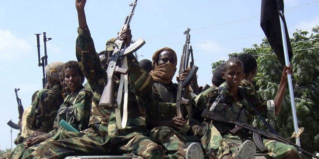 Members of the hardline al Shabaab Islamist rebel group parade through the streets of Somalia's capital Mogadishu, January 1, 2010. 