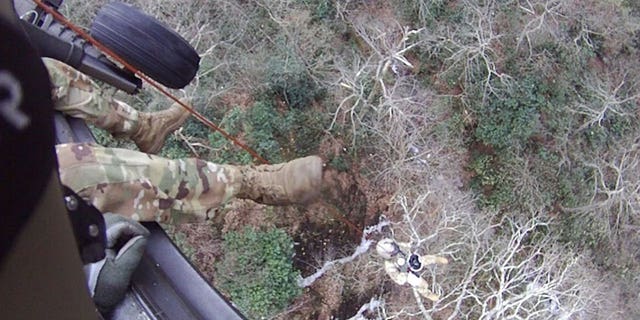 Staff Sgt. Ryan McKnight lowers Staff Sgt. John Sharbel during a recovery mission on the Appalachian Trail, Dec. 31, 2022. Local authorities requested help from the Tennessee Emergency Management Agency and the Tennessee National Guard to rescue two stranded hikers the morning of New Year’s Eve. 