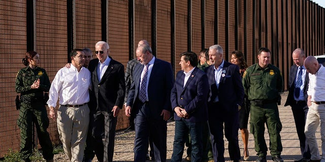 President Biden talks with Rep. Henry Cuellar, D-Texas, second from left, as they walk along a stretch of the U.S.-Mexico border in El Paso, Texas, Sunday, Jan. 8, 2023. 