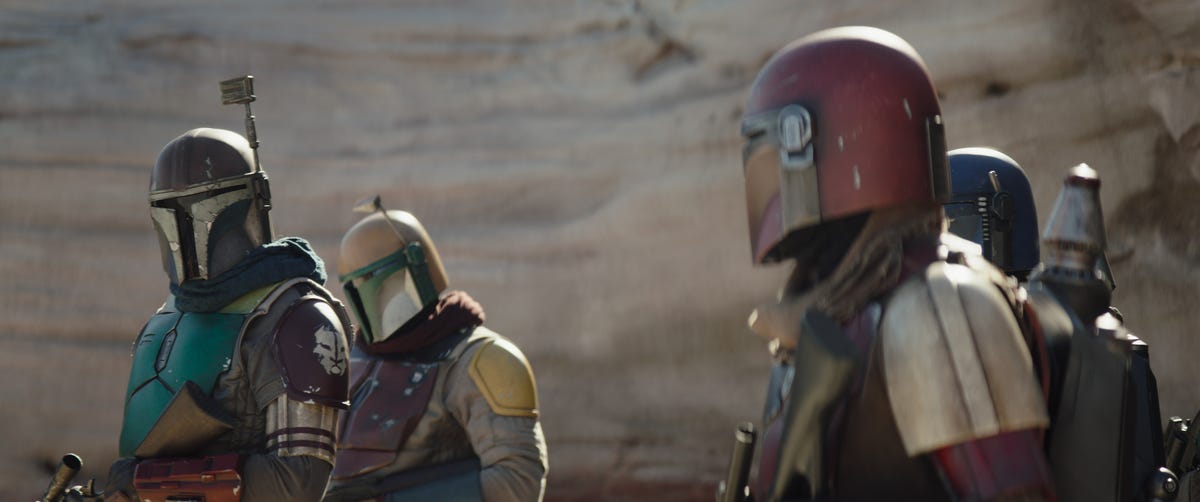 A group of Mandalorians in different colored armor gather in The Mandalorian season 3