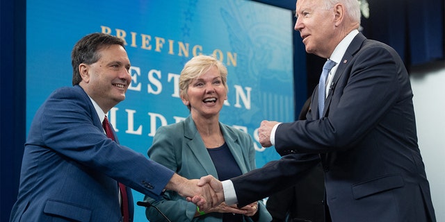 President Biden shakes hands with White House chief of staff Ron Klain alongside Secretary of Energy Jennifer Granholm at the White House on June 30, 2021.