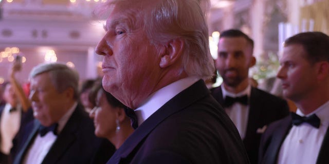 Former President Donald Trump greets people as he arrives for a New Year's event at his Mar-a-Lago home on Dec. 31, 2022, in Palm Beach, Florida.