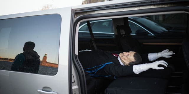 Andreas, 39-year-old, member of the Swedish solidarity committee for Rojava is reflected next to a car carrying an effigy of Turkish President Recep Tayyip Erdogan on Jan. 16, 2023, in Stockholm. Their action, and the pro-Kurdish activists who hanged an effigy of Turkey's president on Jan. 11, 2023, are seen as potentially delaying Sweden's entry into NATO.