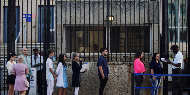 People wait in line to enter the U.S. Embassy in Havana, Cuba, on Jan. 4, 2023.