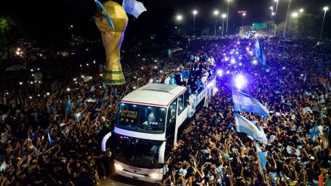 Argentina's players celebrate on board a bus with supporters after winning the World Cup.