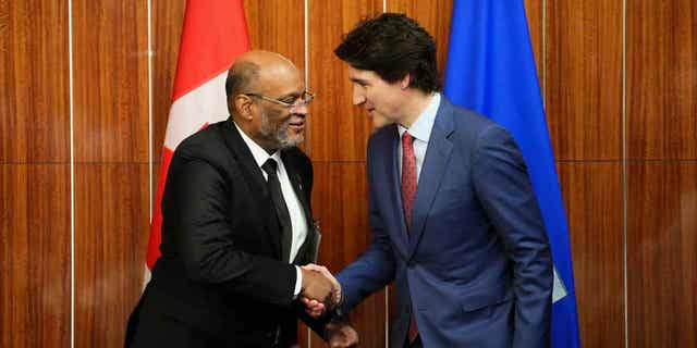 Prime Minister Justin Trudeau, right, shakes hands with the prime minister of Haiti in Nassau, Bahamas, on Feb. 16, 2023.