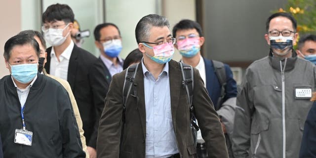 Li Xiaodong (C), an official from China's Taiwan Affairs Office in Shanghai, arrives at the Songshan Airport in Taipei on Feb. 18, 2023.