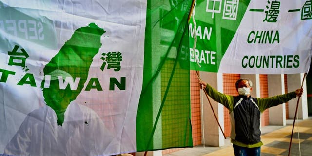 Pro-Taiwan independence activists display banners during a protest before Chinas Taiwan Affairs officials arrive in Taipei on Feb. 18, 2023.