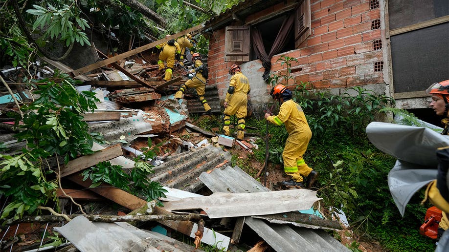 Rescuers looking through debris.