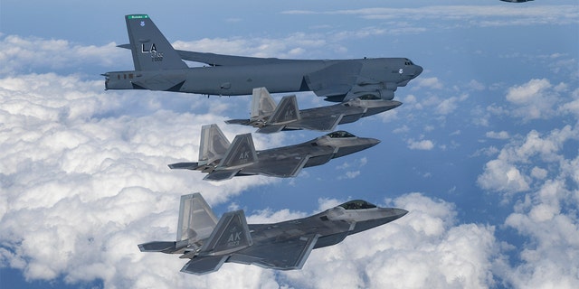 In this photo provided by South Korean Defense Ministry, A U.S. B-52 bomber, C-17 and South Korean Air Force F-35 fighter jets fly over the Korean Peninsula during a joint air drill in South Korea, Tuesday, Dec. 20, 2022.