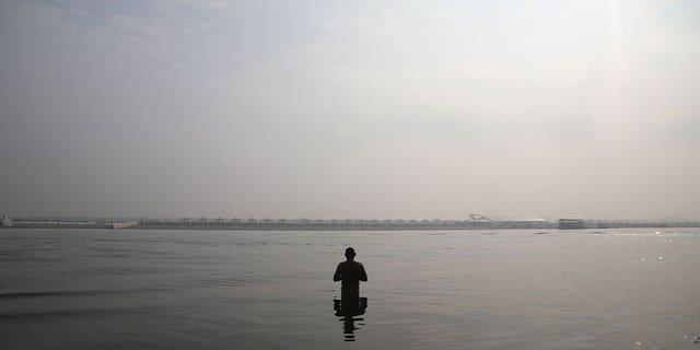 Man prays in Ganges River