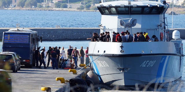 greek coast guard carrying migrants