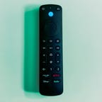 Amazon Fire TV Alexa Voice Remote Pro on a green background.