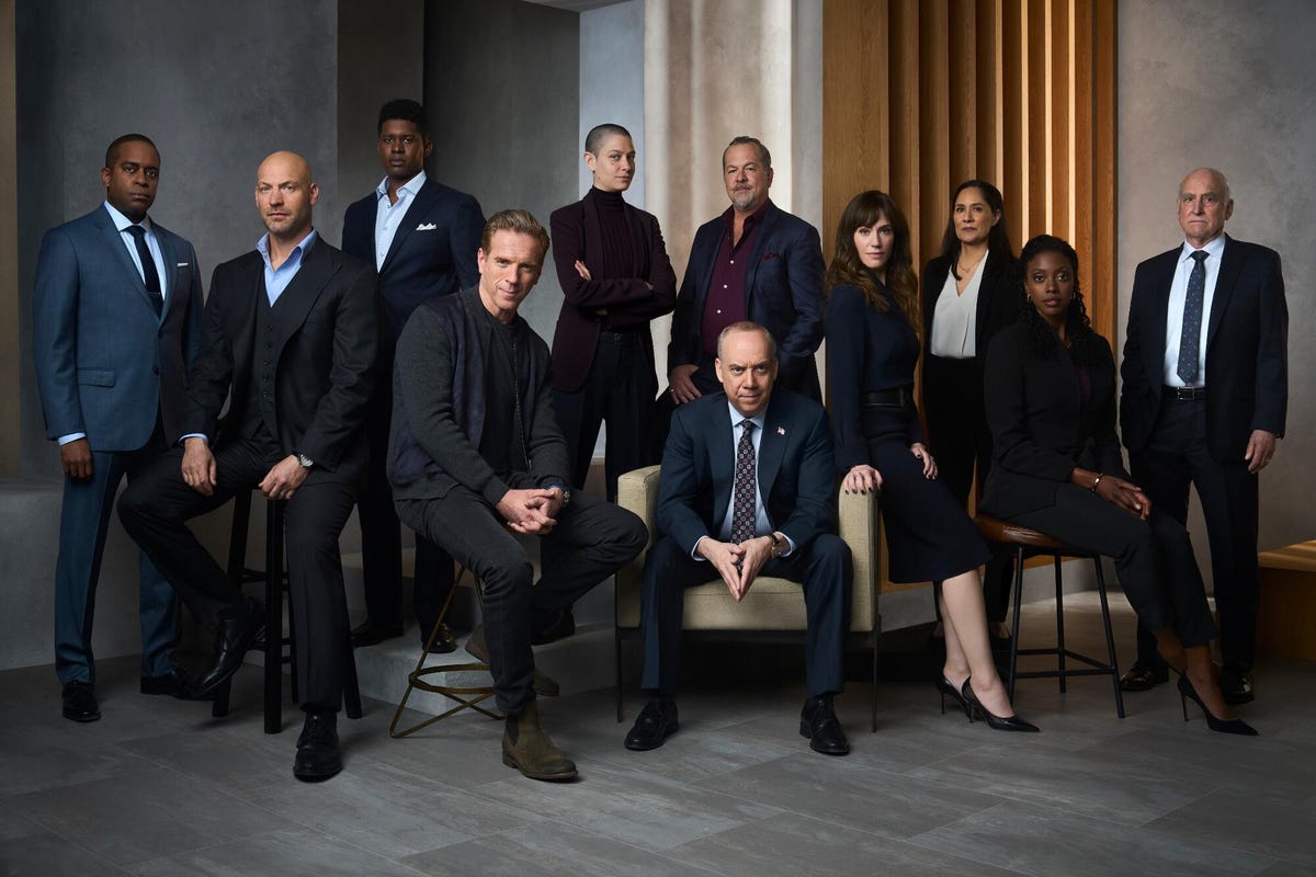 cast of Billions dressed in suits posing for a photo