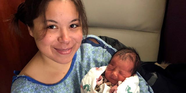 destinee thompson holds baby