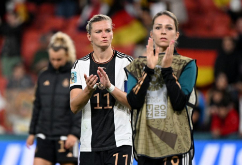 German players react after they crashed out of the tournament following a 1-1 draw with South Korea on August 3.