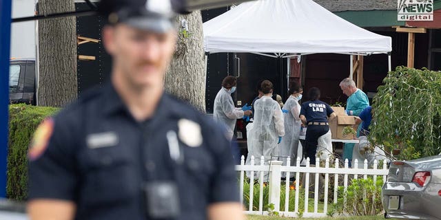 Authorities carry items out of Rex Heuermann's home in Massapequa Park