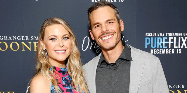 granger smith with wife amber on red carpet