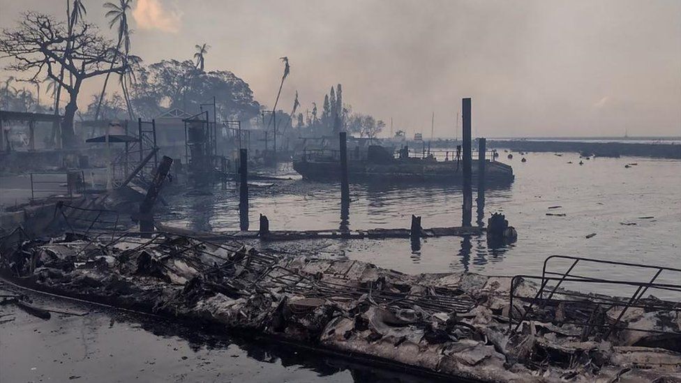 A charred boat lies in the scorched waterfront after wildfires fanned by the winds of a distant hurricane devastated Maui's city of Lahaina, Hawaii, U.S. August 9, 2023.