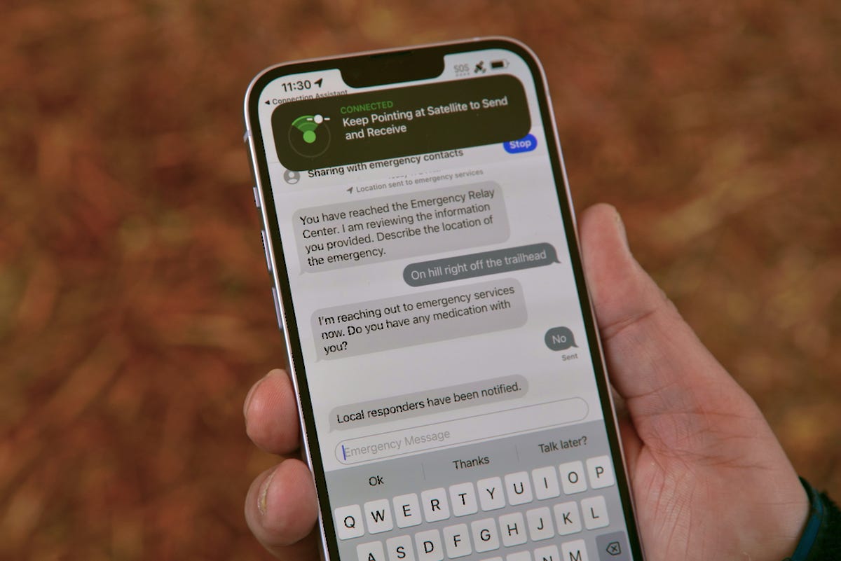 An iPhone 14 showing a text conversation with emergency dispatchers