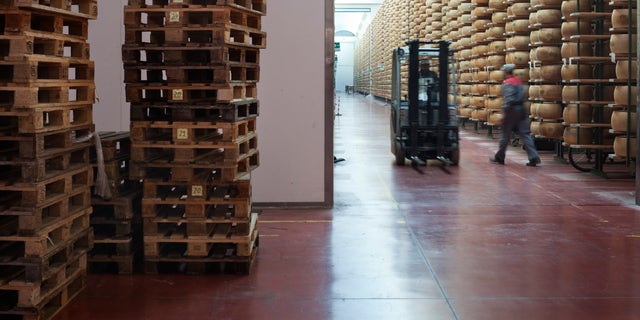 cheese stacked high on shelves in warehouse