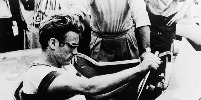 James Dean sitting in a sports car