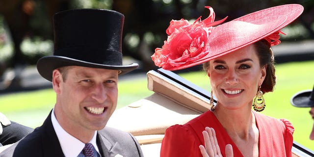 A photo of Prince William and Kate Middleton riding in a carriage