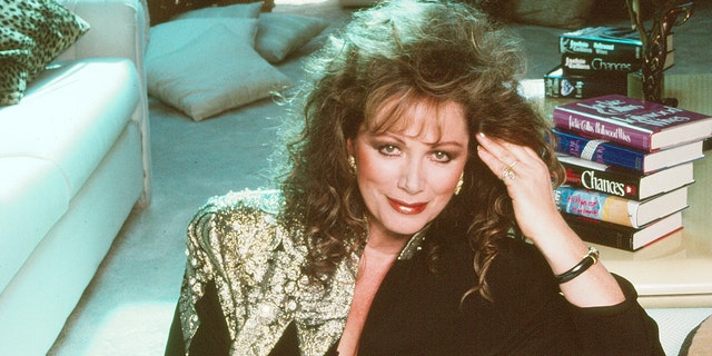 A close-up of Jackie Collins in a gold and black dress