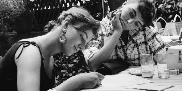 Joan Collins watching her sister Jackie Collins write