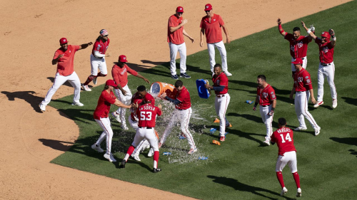 CORRECTS TO WALKOFF SINGLE NOT WALKOFF HOME RUN - The Washington Nationals celebrate after Jeter Downs hit a walk-off single during the ninth inning of a baseball game against the Oakland Athletics, Sunday, Aug. 13, 2023, in Washington. (AP Photo/Stephanie Scarbrough)