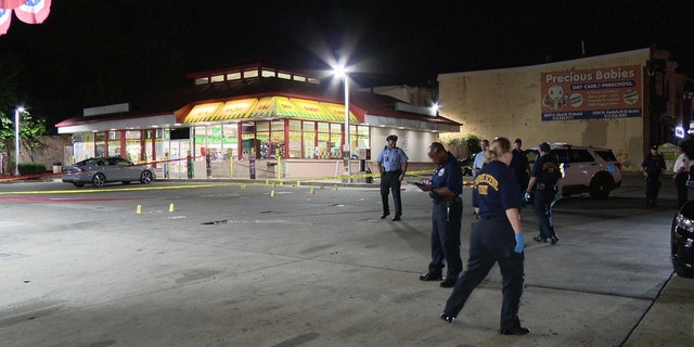 officers investigating gas station scene
