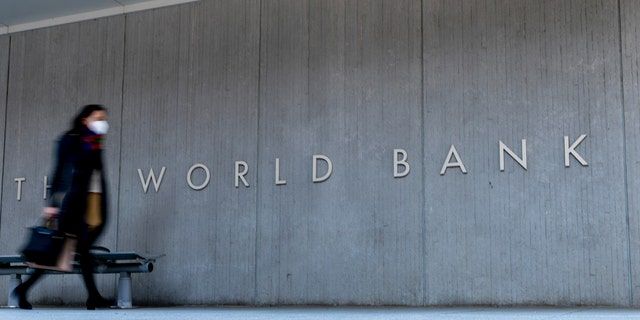 World Bank sign on building as person walks by