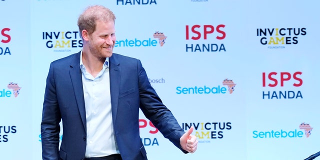 prince harry taking the stage at the sports summit in japan