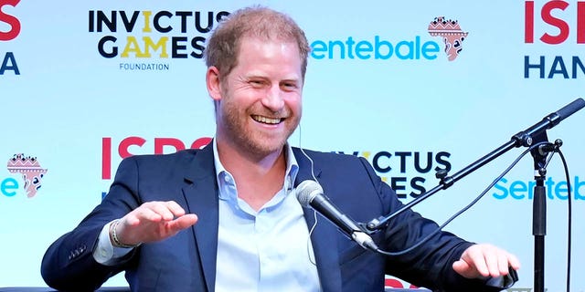 prince harry sitting on panel at sports summit in japan