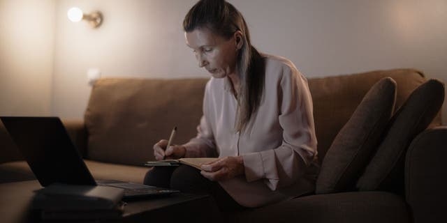 Woman doing her research on what scams to look out for.