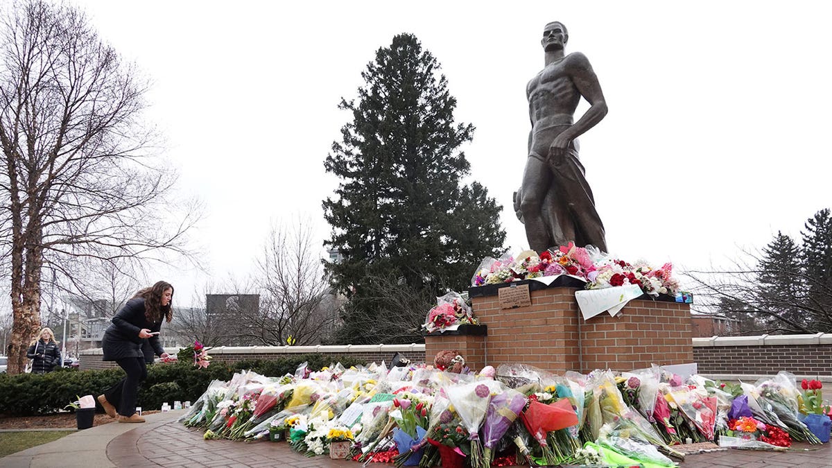 people at tribute over Michigan State University shooting