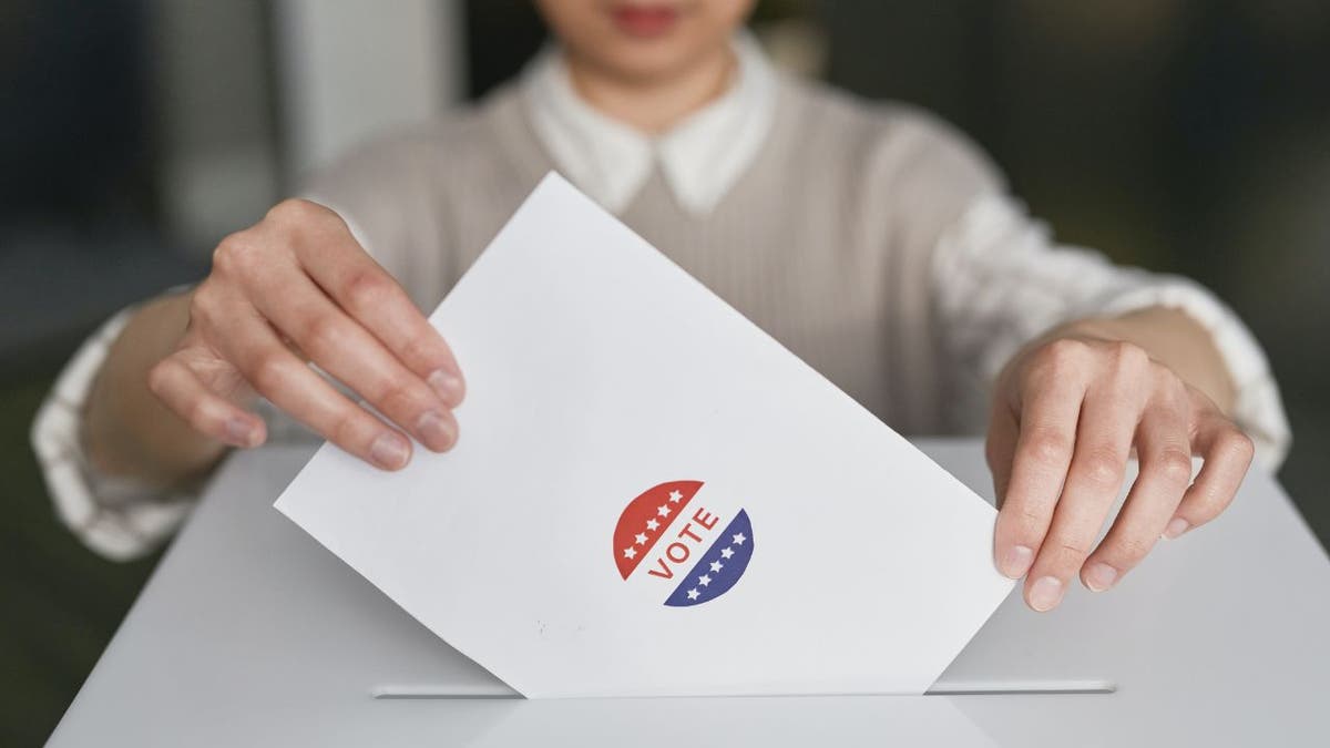 Woman casting a ballot.