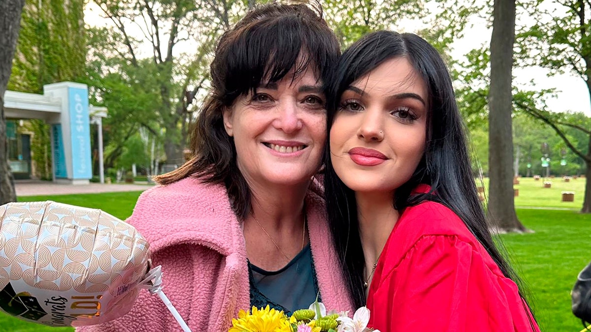 Judith and Natalie Raanan pictured together. Natalie wears a graduation gown.