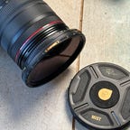 image of a filter on a camera lens with case nearby